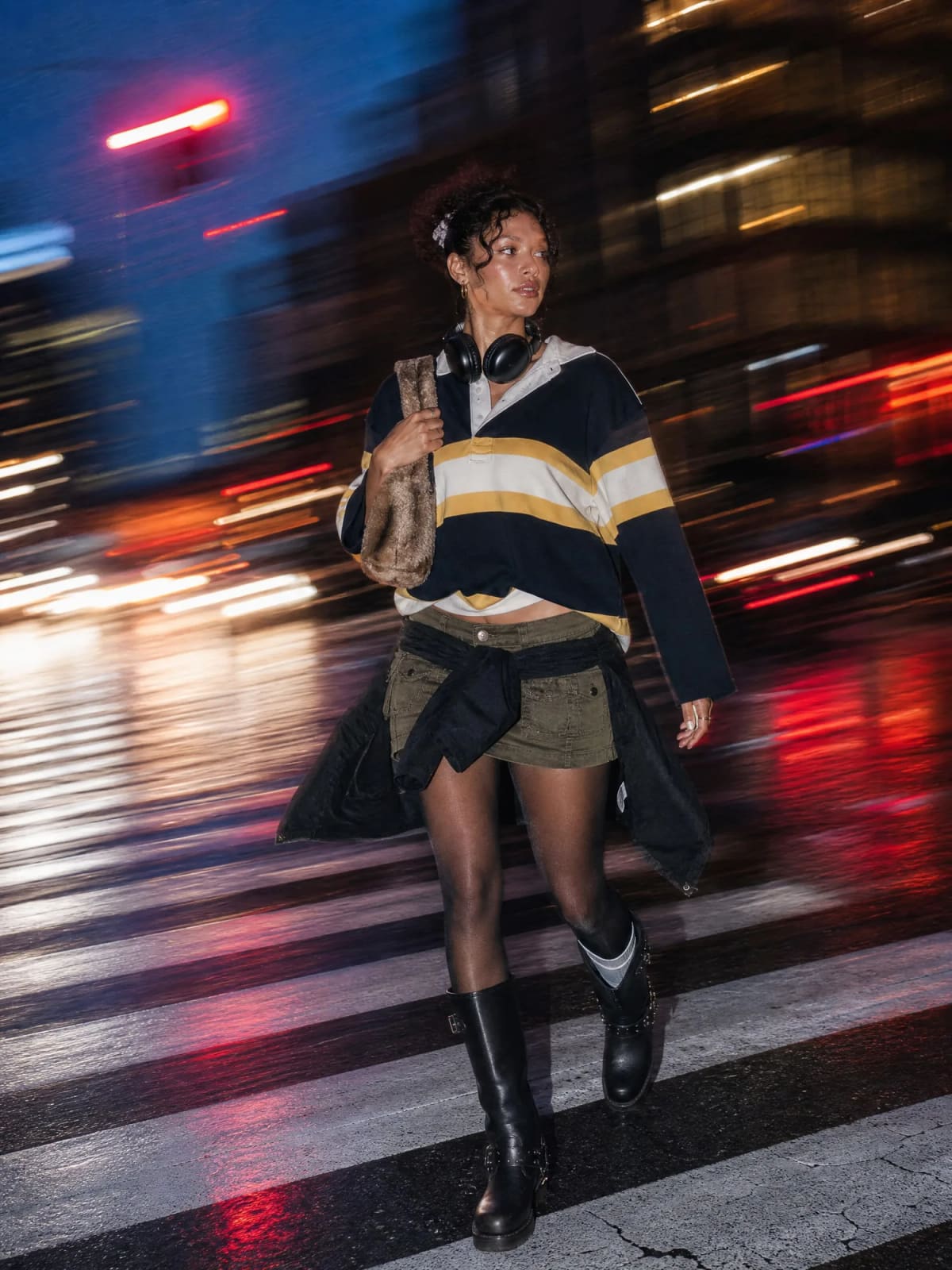 Model walking through motion-blurred city traffic lights