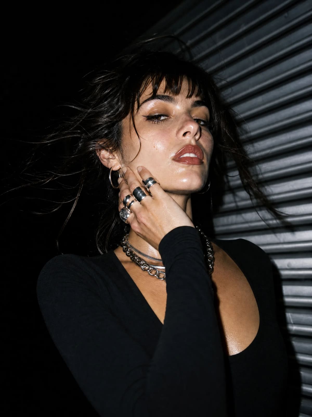Model in black with silver rings and chains